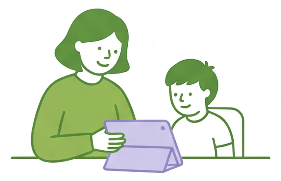 Support worker and boy looking at a tablet together at a table