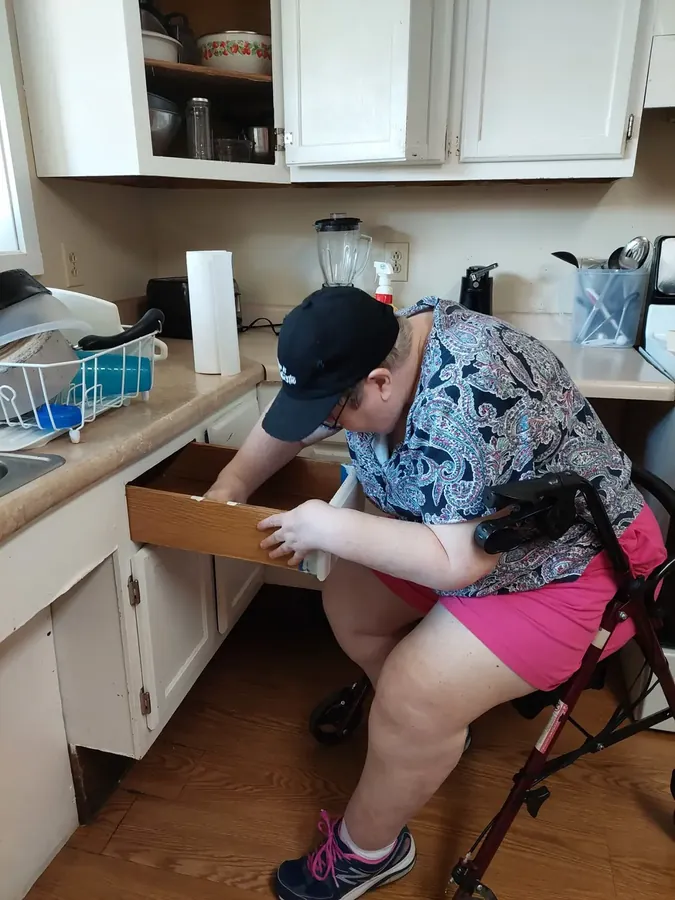 Participant working on kitchen skills at home