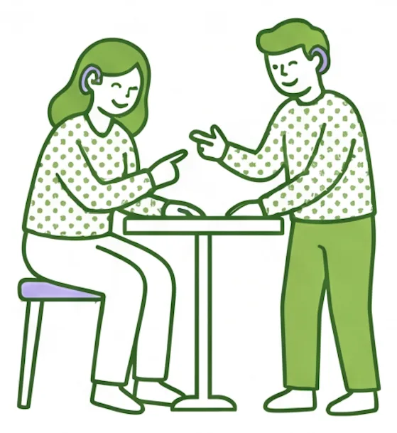 Support worker and participant communicating in sign language across a table
